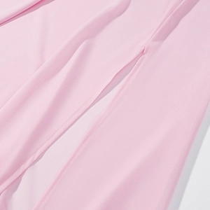 Close-up detail of pink high-waist skirt showing fine stitching and split hem craftsmanship