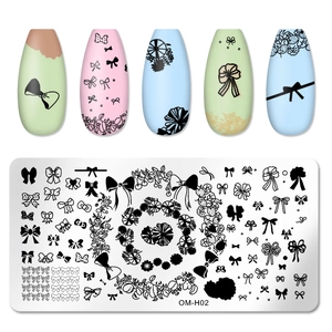 Macro view of rectangular nail stamping plate OM-H02 with bow and ribbon pattern details