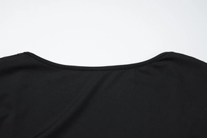 Detail of square neckline with lace patchwork and fine stitching on black dress