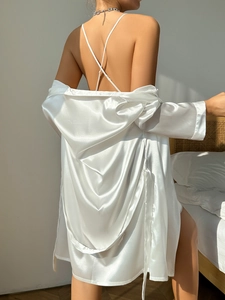 Rear view of white satin sleepwear set showing smooth drape and glossy silk texture