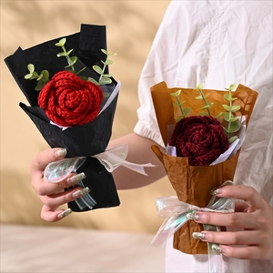 Handmade knitted red rose bouquets in elegant paper wrapping held by a model
