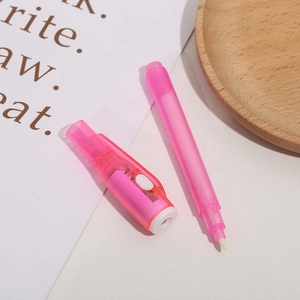 Pink UV magic invisible ink pen with LED light on a decorative wooden tray