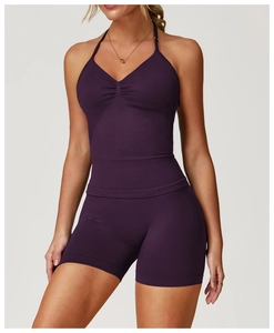Detail of a dark purple halter yoga vest featuring a ruched front and seamless fabric