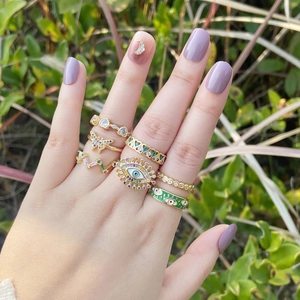 Gold layered ring set with butterfly, evil eye, and colorful zircon stones on model