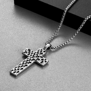 Detail shot of vintage punk silver cross necklace with abstract geometric 3D textures