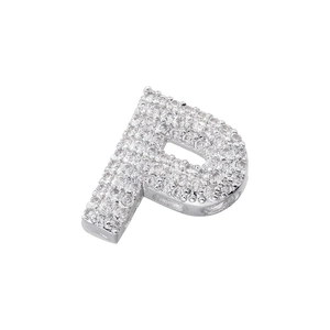 Macro shot of a silver letter P pendant with micro-paved sparkling cubic zirconia stones