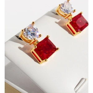 Elegant gold earrings with red rectangular stones and heart zircon on white display