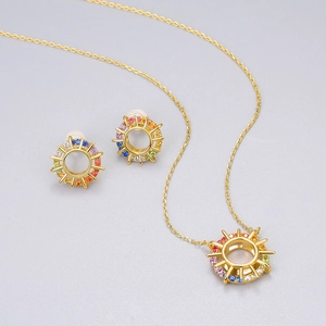 Golden sunburst necklace and earrings set with rainbow gradient cubic zirconia