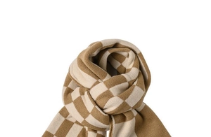 Close-up of soft knit winter scarf with brown and beige checkerboard pattern texture