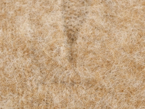 Dettaglio macro del tessuto polo di alta qualità con una morbida trama in lana beige