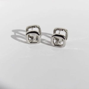 Minimalist silver geometric double square frame drop earrings on a white background