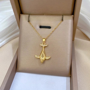 Elegant gold whale pendant necklace featuring shimmering crystals on a fine link chain