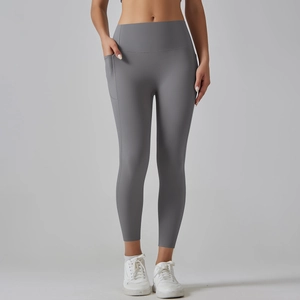 Detail view of high-waisted gray yoga leggings showing a functional side phone pocket