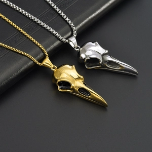 Punk style stainless steel bird skull pendants in gold and silver finishes on black background