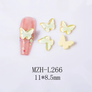 Detail view of 11x8.5mm iridescent yellow butterfly nail charms with pearlescent finish