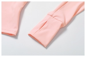 Detail view of pink sports top featuring functional thumbholes on the elastic sleeve cuffs