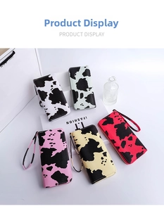 Detailed view of long cow print wristlet wallets in multiple colors with zip closure