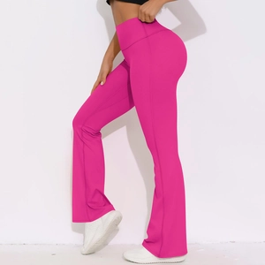 Macro side view of high-waisted flared yoga pants in vibrant rose red breathable fabric