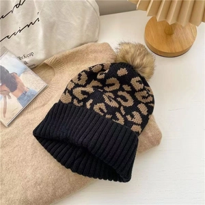Chic leopard print knit beanie for women with brown faux fur pom pom and folded cuff