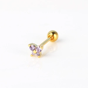 Detailed macro view of a butterfly cartilage stud earring with golden-purple zircon stones