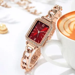 Elegant rose gold rectangle watch with red dial and diamond bezel on a chain strap