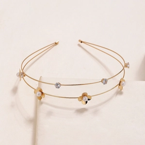 Elegant gold double-layered floral headband with pearls and rhinestones on beige block