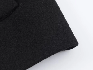 Detailed macro shot of high-quality black cashmere coat fabric showing fine texture