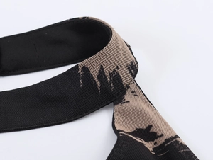 Detailed macro view of the woven printed halter strap on a stretch bodycon dress