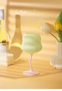Detail of macaron cream twist glass with a soft green bowl and pink spiral stem