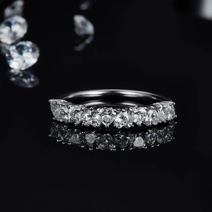 Moissanite ring in 925 silver with heart-cut stones on a reflective black background