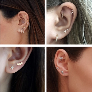 Detailed views of 925 silver stud earrings with star, moon, and rhinestone chain designs
