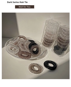Detailed close-up of dark grey gradient spiral telephone wire hair ties in a luxury set