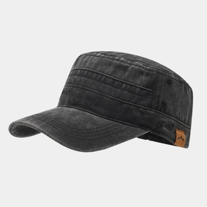 Detail of black washed cotton cadet cap with brown leather mountain logo patch