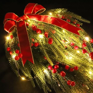 Hanging Christmas teardrop swag with red berries, velvet bow and warm LED lights