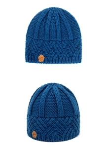 Detail of royal blue chunky knit beanie showing rib texture and brown leather label