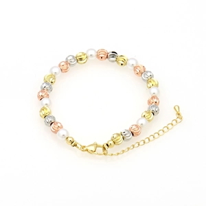 Detail of three-tone metal beads and white pearls bracelet with lobster clasp