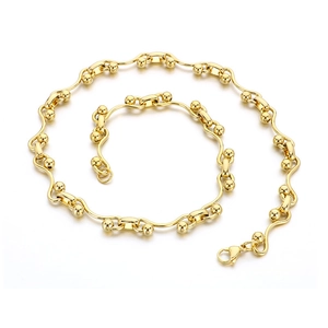 Elegant gold wavy chain necklace with small beads and a lobster clasp on white background