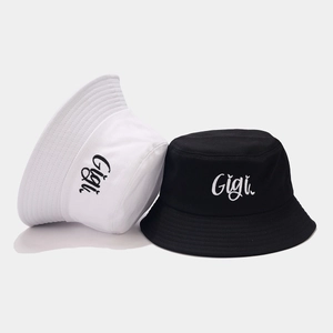 Classic cotton bucket hats in black and white with Gigi embroidery on simple gray background