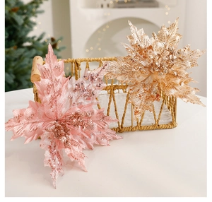 Detailed close-up of pink and gold glittery Christmas flower ornaments in a woven basket