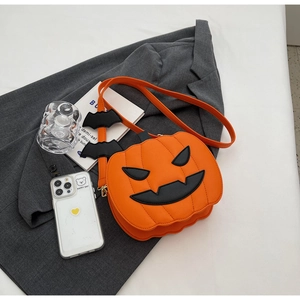 Detail view of pumpkin shaped bag with black bat shoulder strap and Jack-o'-lantern face