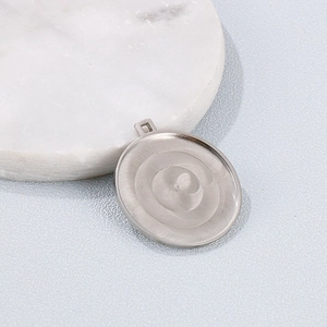 Polished silver stainless steel round pendant base with concentric texture and top loop