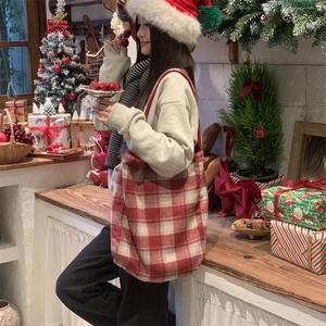 Detail of red plaid canvas tote bag in a festive Christmas holiday setting