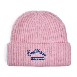 Detail of pink rib-knit beanie featuring navy blue Bestchoise embroidery and textile label