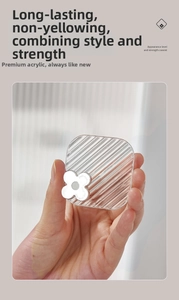 Macro shot of luxury clear acrylic adhesive hook with a silver floral mirror detail