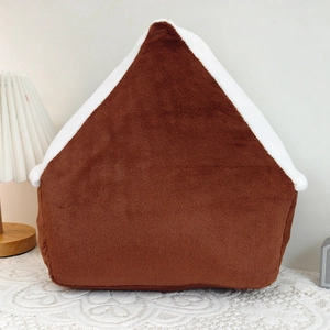 Cozy brown plush house pillow with soft white roof in a warm home decor setting