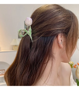 Detail of lavender tulip hair claw clip holding hair in a stylish updo on a model