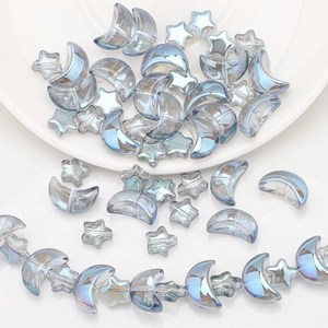 Detailed view of iridescent star and moon glass beads for DIY jewelry making
