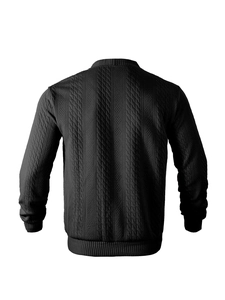 Macro detail of high-density black knit sweater featuring 3D cable stitch and ribbed cuffs