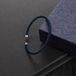 Detailed macro view of the blue steel wire mesh woven cable bracelet with polished ends