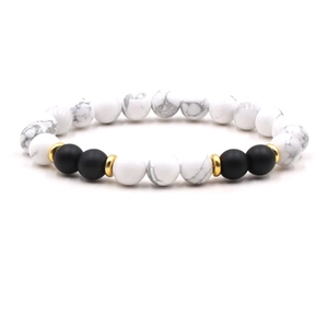 Macro detail of elastic beaded bracelet with white turquoise and matte black agate stones